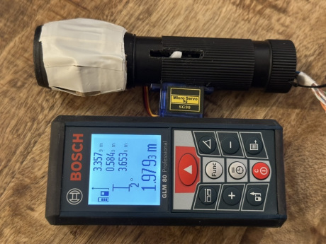 FeelBeam prototype on the table. The lever is in the middle position, indicating a mid-range distance.